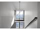 Contemporary staircase with modern light fixture and views from landing at 199 14Th St # 3003, Atlanta, GA 30309