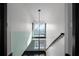 Bright staircase featuring glass railing and a contemporary light fixture at 199 14Th St # 3003, Atlanta, GA 30309