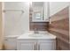 Bathroom with a modern vanity, mirror, accent wall, and a visible toilet to the side at 1077 Mainstreet Valley Dr, Stone Mountain, GA 30088