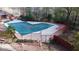 Community pool closed for the season with surrounding fence and trees in a well maintained setting at 1077 Mainstreet Valley Dr, Stone Mountain, GA 30088