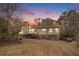 Attractive house exterior at dusk, showcasing a deck and landscaping at 61 Macland Springs Dr, Dallas, GA 30157