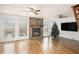 Living room with hardwood floors, stone fireplace, and large windows at 61 Macland Springs Dr, Dallas, GA 30157