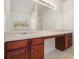Bathroom vanity with dual sinks, wood cabinets, and a large mirror providing ample counter space at 6849 Fireside Ln, Atlanta, GA 30349