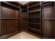 Walk-in closet boasts a dark wood finish with custom shelving and ample storage space at 6849 Fireside Ln, Atlanta, GA 30349