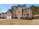 Charming two-story brick home with a manicured lawn and a two-car garage at 6849 Fireside Ln, Atlanta, GA 30349