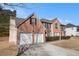 Attractive two-story brick home with an attached two-car garage and lush landscaping at 6849 Fireside Ln, Atlanta, GA 30349