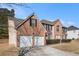 Beautiful two-story brick home with an attached two-car garage and lush landscaping at 6849 Fireside Ln, Atlanta, GA 30349