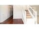 Bright foyer with hardwood floors, decorative wall paneling, and a staircase at 6849 Fireside Ln, Atlanta, GA 30349