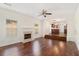Spacious living room featuring hardwood floors, a fireplace, and a step-up kitchen area at 6849 Fireside Ln, Atlanta, GA 30349