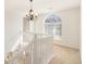 Bright open staircase leading to the upper level with an arched window at 6849 Fireside Ln, Atlanta, GA 30349