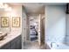Bright bathroom with marble floors, soaking tub, and walk-in shower near bedroom entrance at 126 Henley St, Canton, GA 30114