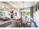 Bright dining room with a fireplace, large windows, modern lighting, and stylish decor at 126 Henley St, Canton, GA 30114