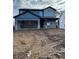 New two-story home with a gray brick facade, two-car garage and unfinished landscaping at 126 Henley St, Canton, GA 30114