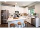 Modern kitchen featuring white cabinets, an island with seating, and stainless steel appliances at 126 Henley St, Canton, GA 30114