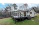 White house exterior with large deck and wooded backdrop at 3465 Callie Still Rd, Lawrenceville, GA 30045