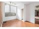 Basement office with hardwood floors, exposed brick, and block window at 1112 Delaware Se Ave, Atlanta, GA 30316