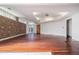 Large basement area with hardwood floors and exposed brick wall at 1112 Delaware Se Ave, Atlanta, GA 30316