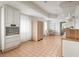 Modern kitchen with white cabinets and terracotta tile floors at 1112 Delaware Se Ave, Atlanta, GA 30316