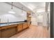 Kitchen with wood cabinets, tile floors, and exposed brick at 1112 Delaware Se Ave, Atlanta, GA 30316