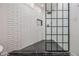 Updated shower with subway tile and black frame glass enclosure at 1112 Delaware Se Ave, Atlanta, GA 30316