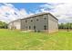 The backyard is spacious and features a well maintained lawn with neutral siding at 311 Bianca Way, Mcdonough, GA 30253