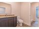 Bathroom featuring granite countertops, a gray vanity, and sleek fixtures at 311 Bianca Way, Mcdonough, GA 30253