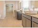 Bright bathroom with a dual sink vanity, granite countertops, and tiled flooring at 311 Bianca Way, Mcdonough, GA 30253