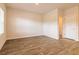 Bright bedroom with hardwood floors, white walls, a window with blinds, and a white door at 311 Bianca Way, Mcdonough, GA 30253
