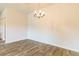 Bright dining room features wood-look floors and a decorative light fixture at 311 Bianca Way, Mcdonough, GA 30253