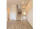 Bright foyer with wood-look flooring, staircase, and natural light at 311 Bianca Way, Mcdonough, GA 30253