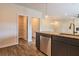 Modern kitchen featuring granite counters, stainless steel appliances, and wood-look flooring at 311 Bianca Way, Mcdonough, GA 30253
