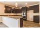 Modern kitchen featuring dark cabinets, granite countertops, and stainless steel appliances at 311 Bianca Way, Mcdonough, GA 30253