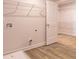 Convenient laundry room with ample shelving and modern wood-look flooring at 311 Bianca Way, Mcdonough, GA 30253