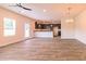 Open-concept living area with hardwood floors and a view of the modern kitchen at 311 Bianca Way, Mcdonough, GA 30253