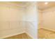 Spacious walk-in closet featuring neutral carpeting and ample shelving space for optimal storage solutions at 311 Bianca Way, Mcdonough, GA 30253