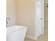 Modern bathroom featuring a freestanding tub and tile floors at 305 Bianca Way, Mcdonough, GA 30253