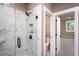 Modern bathroom features a glass-enclosed shower with marble tile and black fixtures, next to a separate toilet room at 106 Henley St, Canton, GA 30114