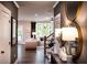 Stylish entryway with hardwood floors, decorative mirrors, and a view of the living room at 106 Henley St, Canton, GA 30114