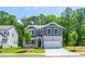 Beautiful two-story home features stone accents, a well-kept lawn, and a welcoming facade at 106 Henley St, Canton, GA 30114
