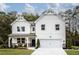 Charming two-story modern farmhouse featuring a two-car garage, covered porch, and board and batten siding at 106 Henley St, Canton, GA 30114