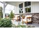 Inviting front porch featuring brick accents and comfortable seating, perfect for enjoying the outdoors at 106 Henley St, Canton, GA 30114