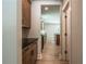 Hallway view to modern kitchen featuring sleek countertops, stainless steel appliances, and hardwood floors at 106 Henley St, Canton, GA 30114