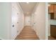 Hallway features neutral walls, white trim, hardwood flooring and views toward entry door at 106 Henley St, Canton, GA 30114