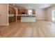 Open kitchen and living room showcasing an island with black countertops and ample cabinet space, perfect for modern living at 106 Henley St, Canton, GA 30114