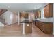 Modern kitchen featuring an island with black countertop, hardwood floors, and cabinetry, seamlessly connected to the living area at 106 Henley St, Canton, GA 30114