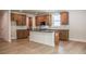 Well-lit kitchen features wooden cabinets, a white center island with a black countertop, and tile backsplash at 106 Henley St, Canton, GA 30114