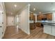 Open-concept view from the hall showcases a kitchen with hardwood floors, modern appliances, and sleek countertops at 106 Henley St, Canton, GA 30114