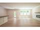 Spacious living area flows into a kitchen and features a fireplace and door to the outside, ideal for relaxation at 106 Henley St, Canton, GA 30114