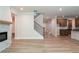 Inviting living room showcases a fireplace, staircase, and light hardwood floors, creating a warm and spacious atmosphere at 106 Henley St, Canton, GA 30114