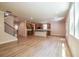 Bright open-concept living area with hardwood floors, a staircase, and kitchen with an island, ideal for entertaining at 106 Henley St, Canton, GA 30114
